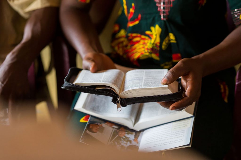 Woman in African dress reading the Bible