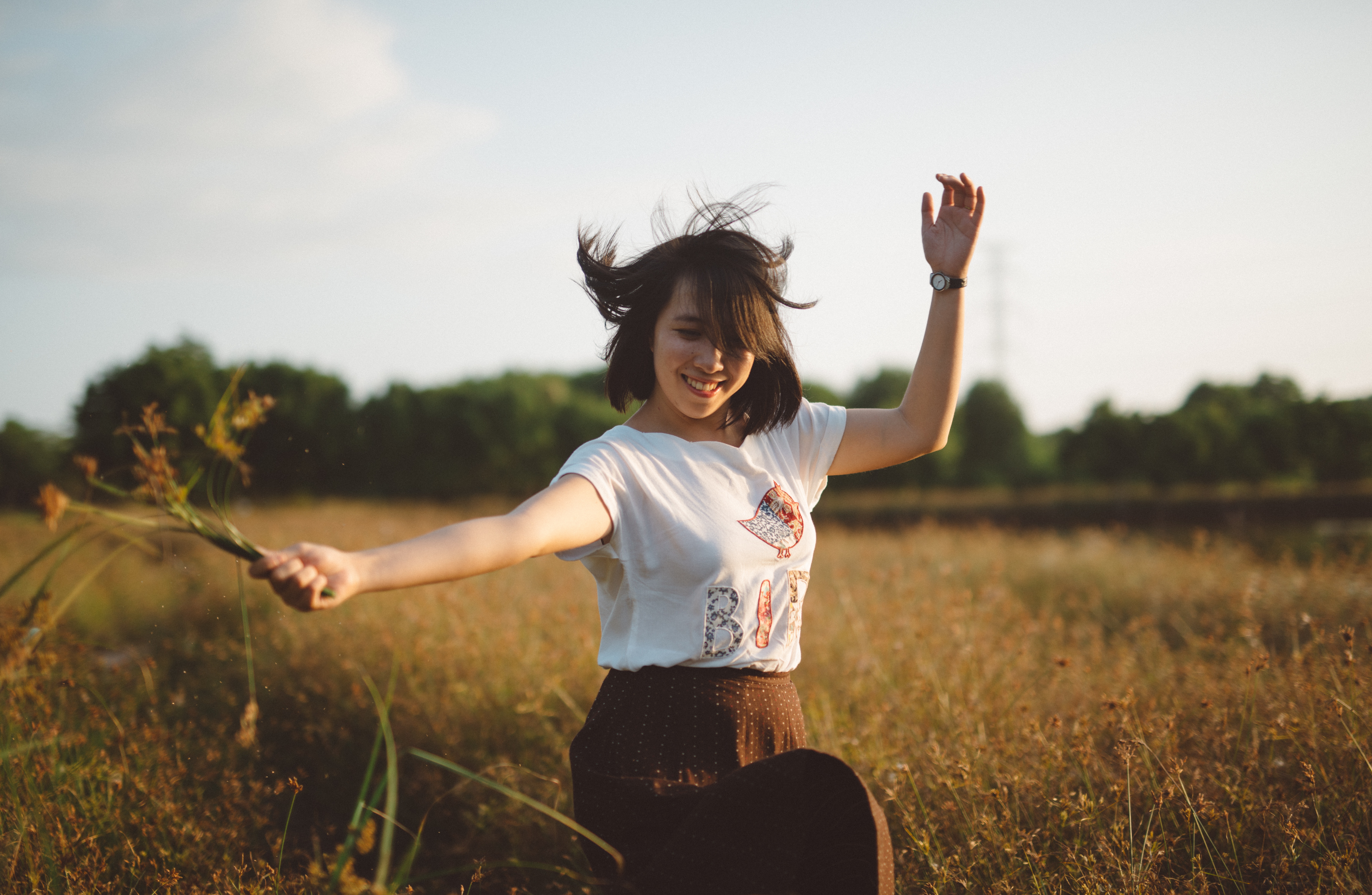 Picture of a girl dancing in a field of wheat