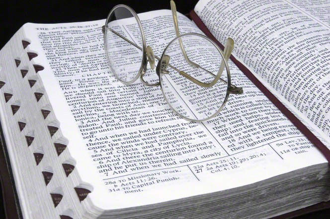 glasses on scriptures