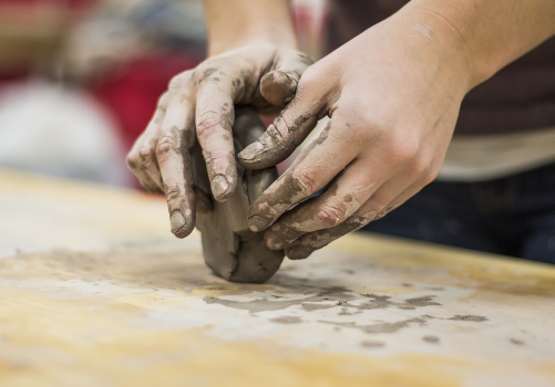 Hands molding a piece of clay