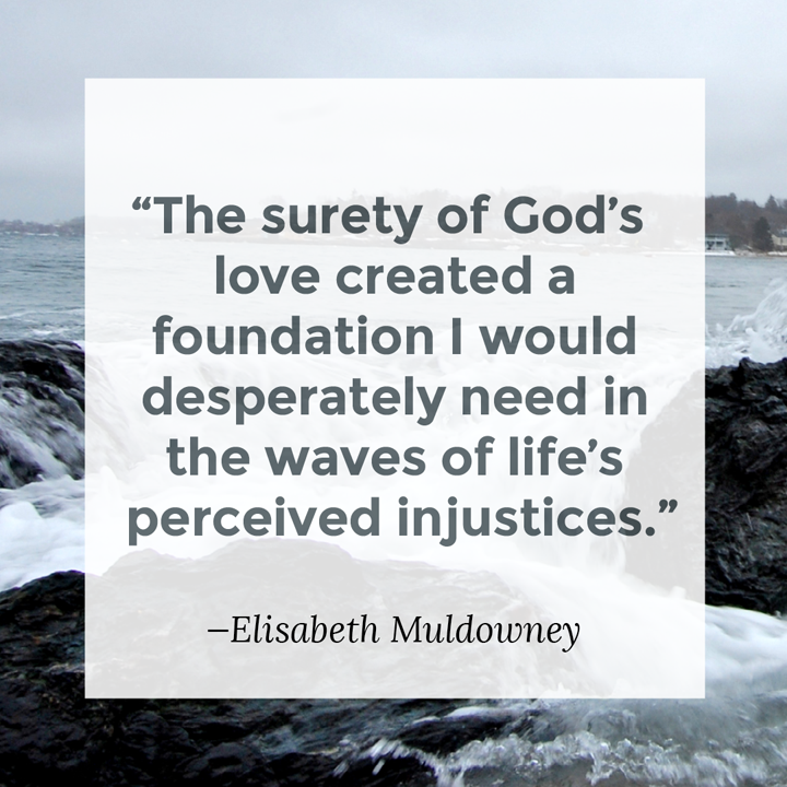 A text box overlays ocean waves crashing over rocks. Text reads, "The surety of God's love created a foundation I would desperately need in the waves of life's perceived injustices" (Elizabeth Muldowney)