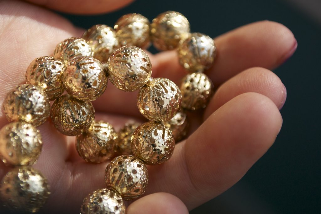 gold beads in a hand