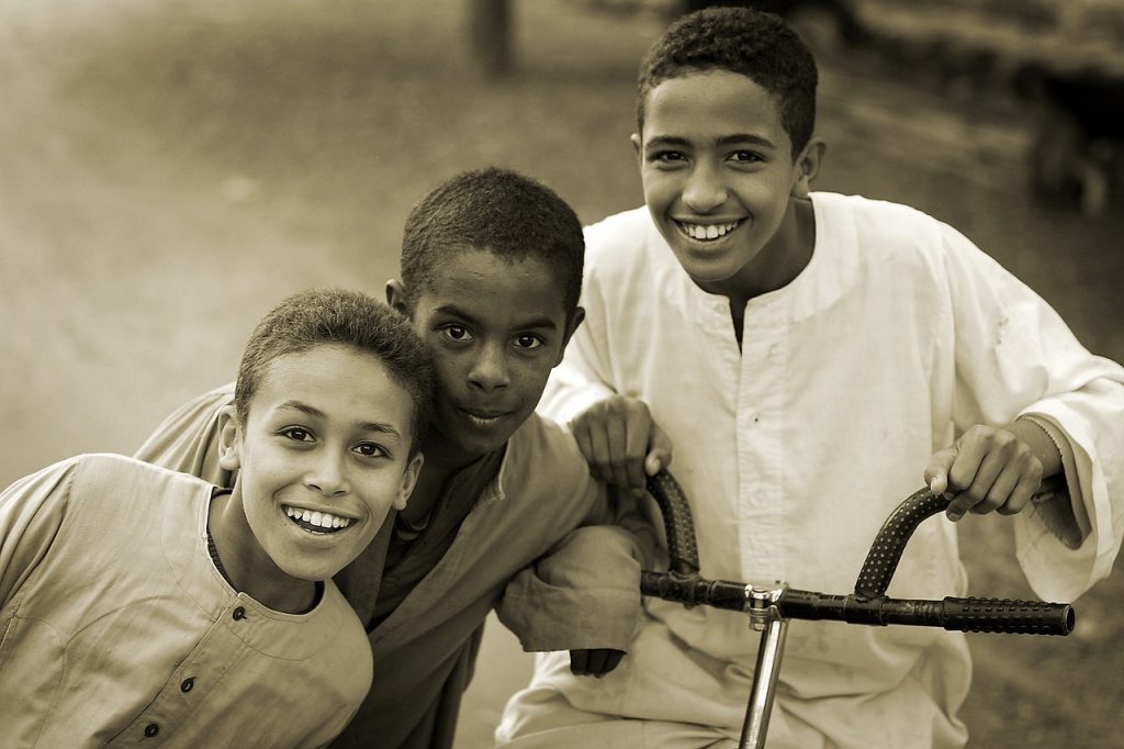 A photo of three smiling young fellows.