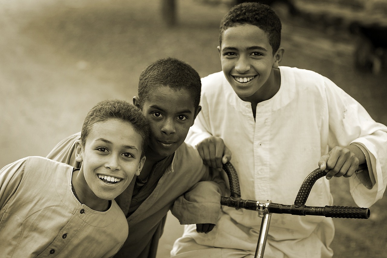 A photo of three smiling young fellows.