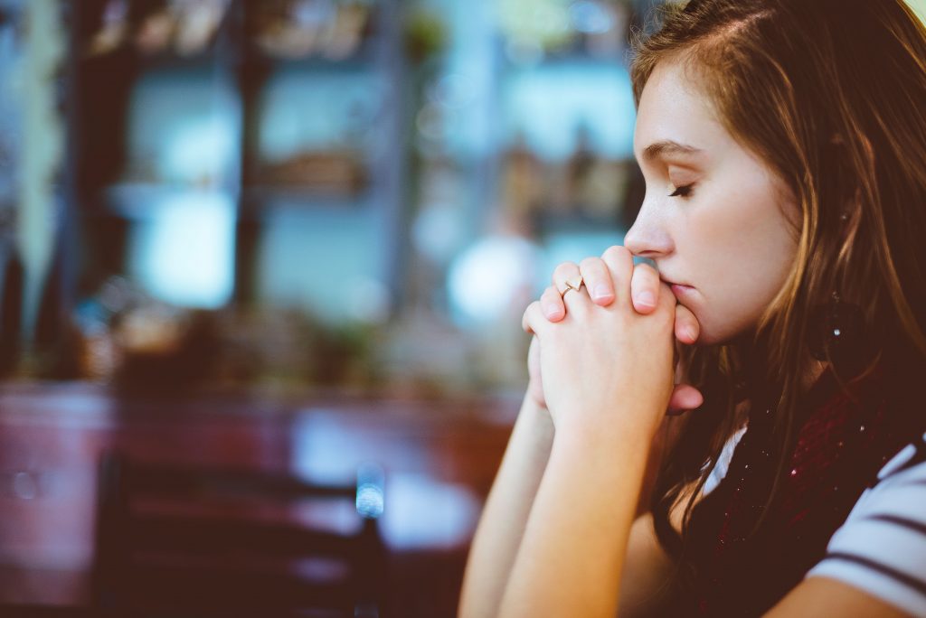 girl praying and background unfocused