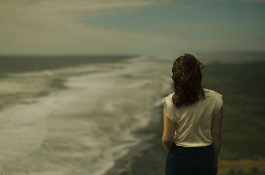 Woman staring at the ocean