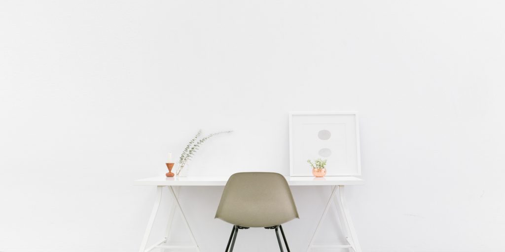A desk on a white wall.