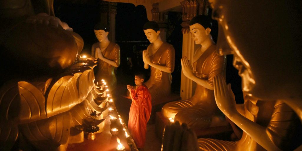Boy praying in Buddhist temple