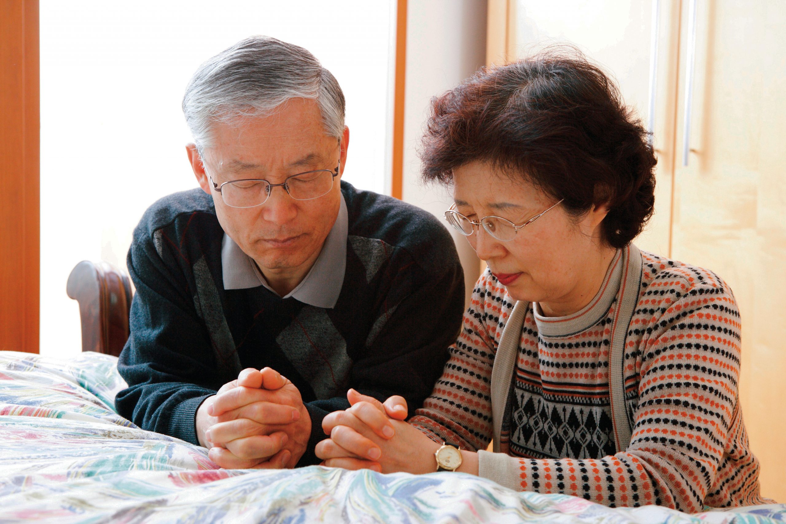 Two people praying together.