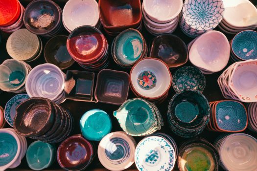 An aerial view of many different, multi-colored ceramic bowls