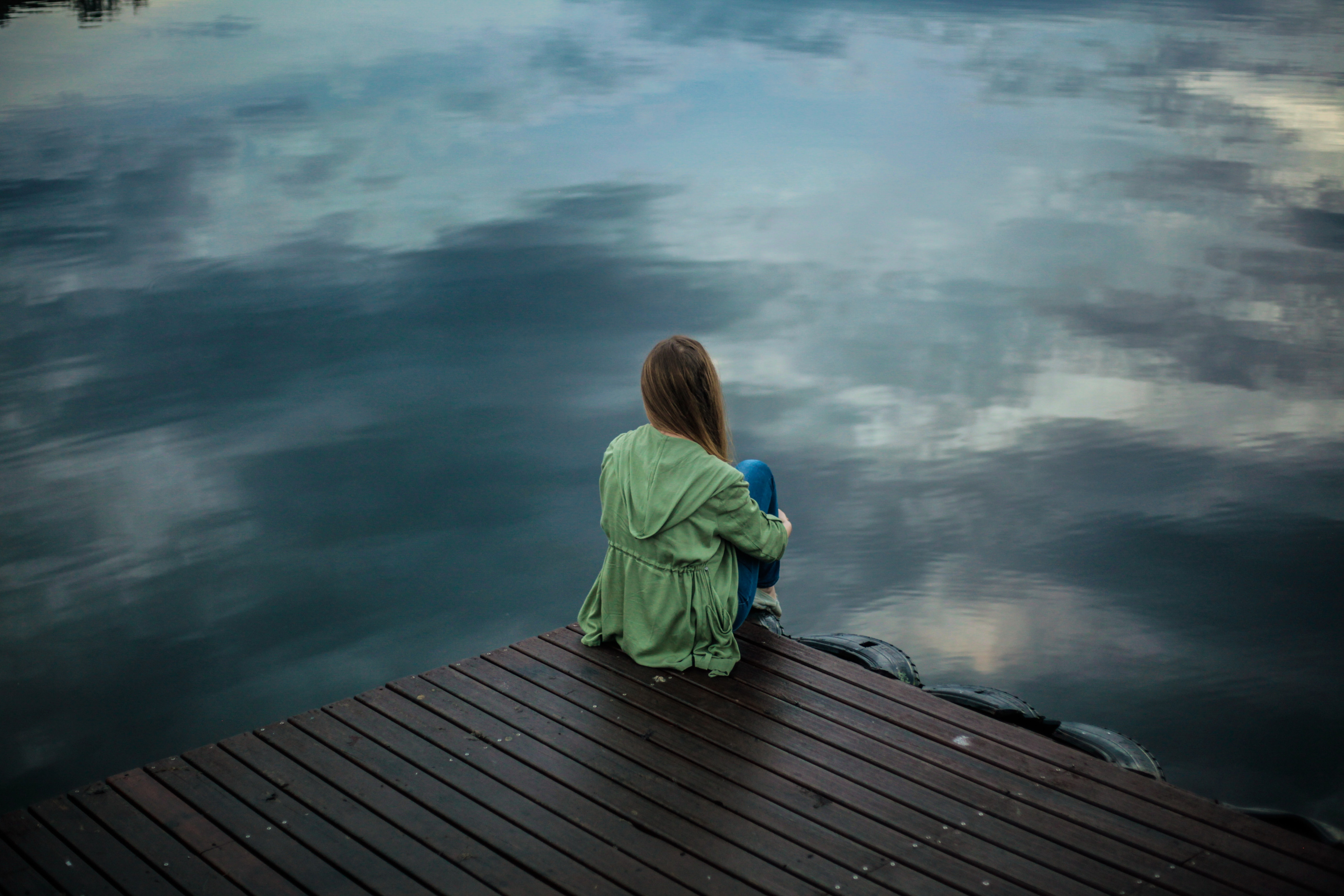 Woman sitting on a pier.