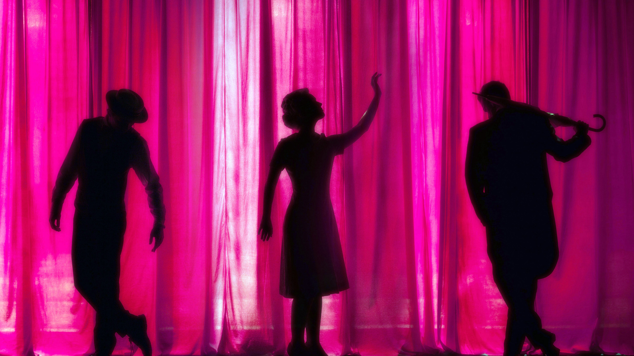 3 Silhouetted performers