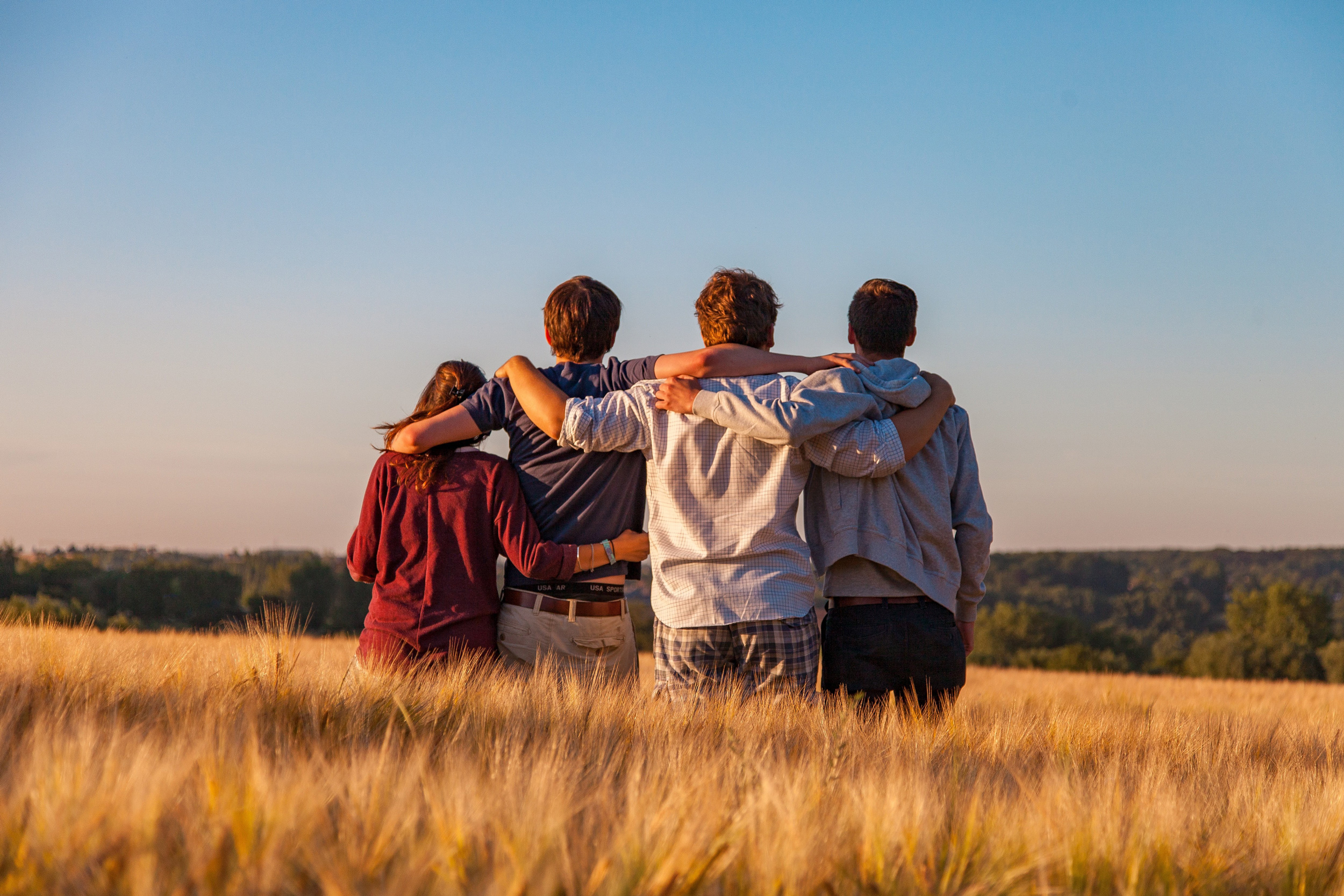 Four young people in a side hug