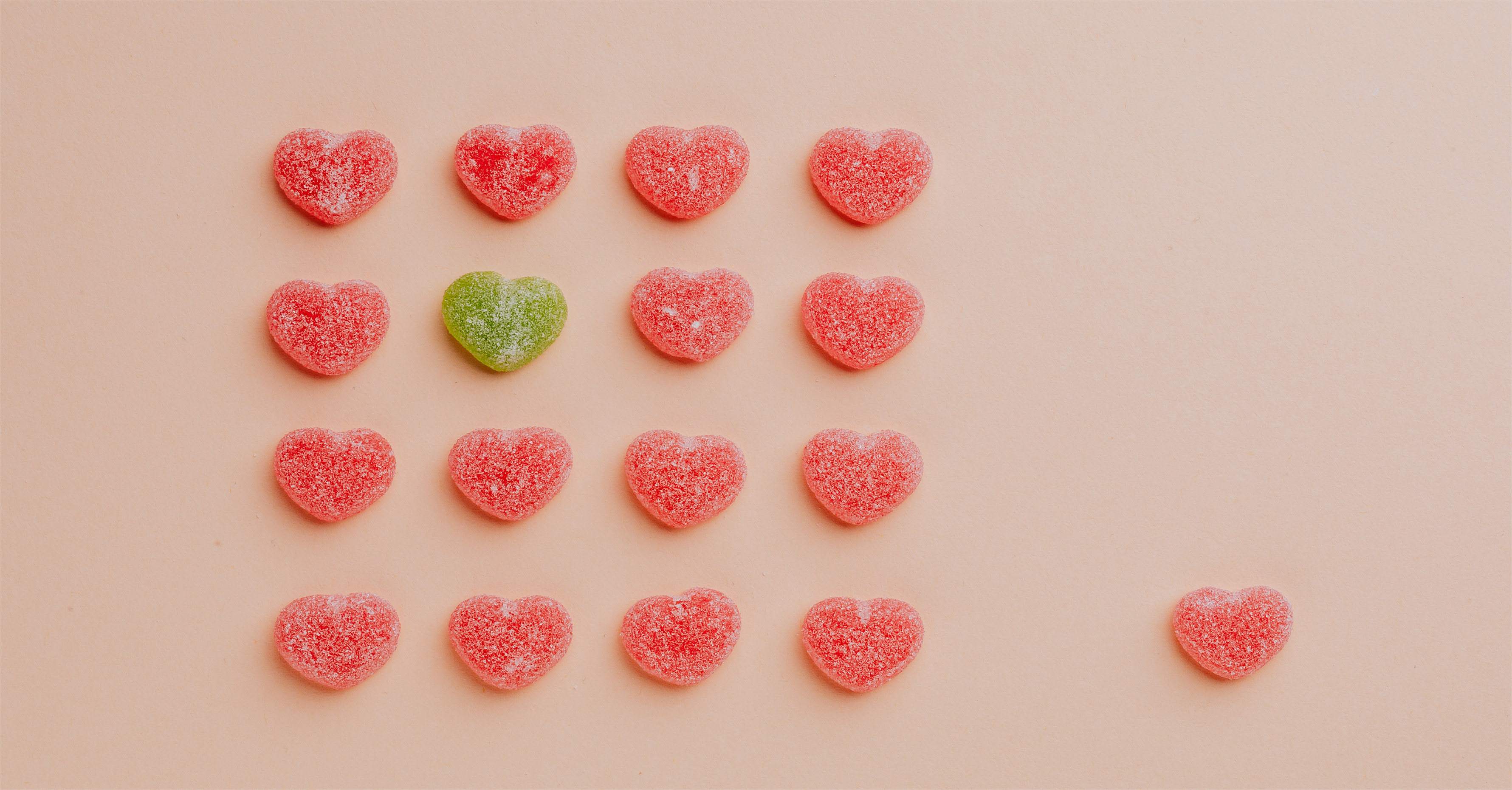 Red hearts in a row with one green heart standing out