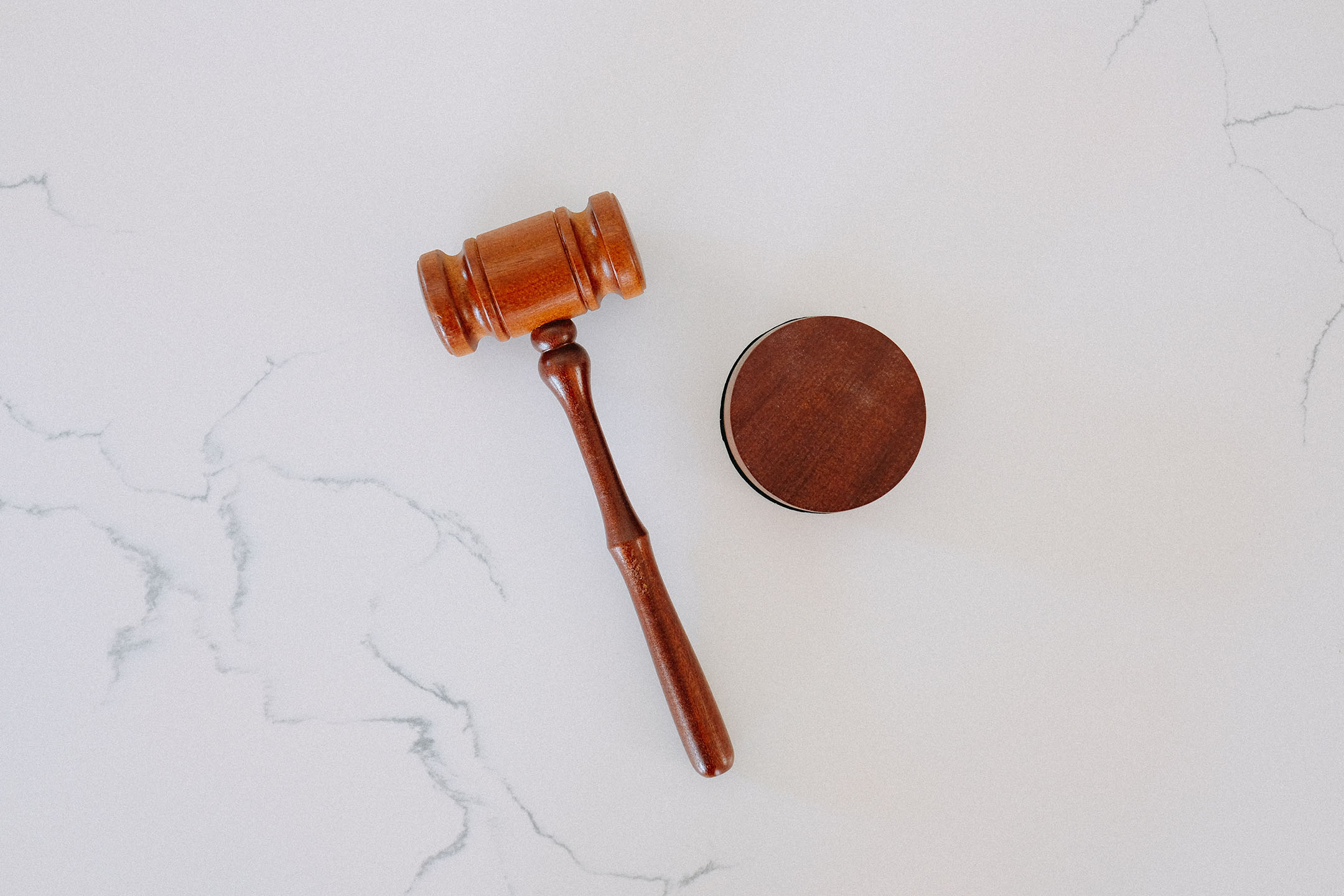 a gavel on a white marble background