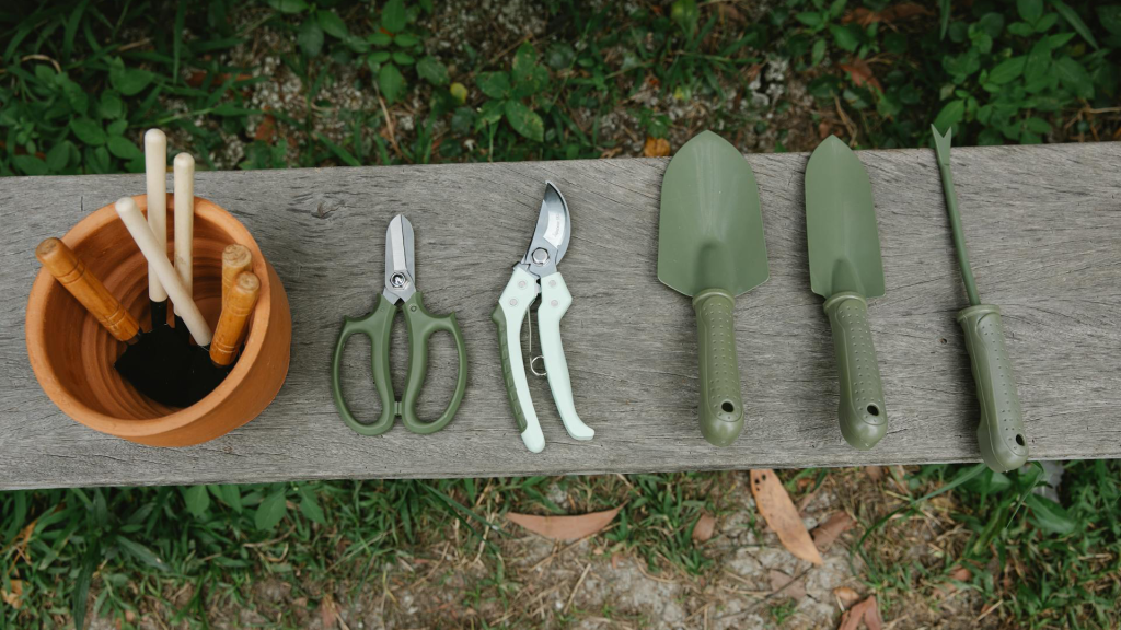 Aerial view of gardening tools placed on a bench.