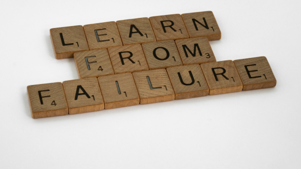 Scrabble tiles on a white background that spell out “learn from failure.”